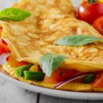 omelet with vegetables and cherry tomatoes